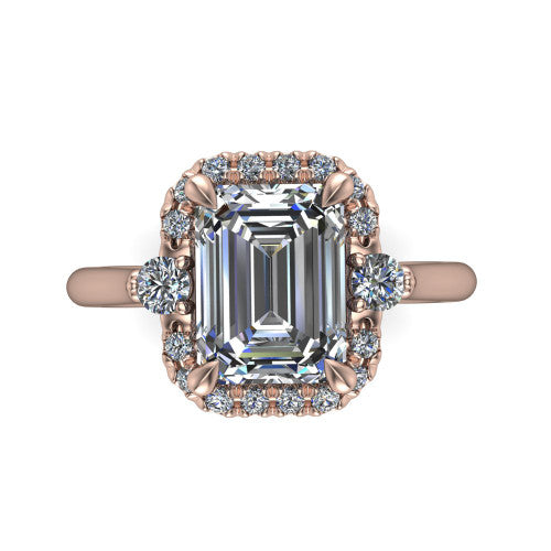 Riley emerald halo engagement ring in 18K Rose Gold with squared pavé halo and round side accents, top-down view of the squared halo and round side accents