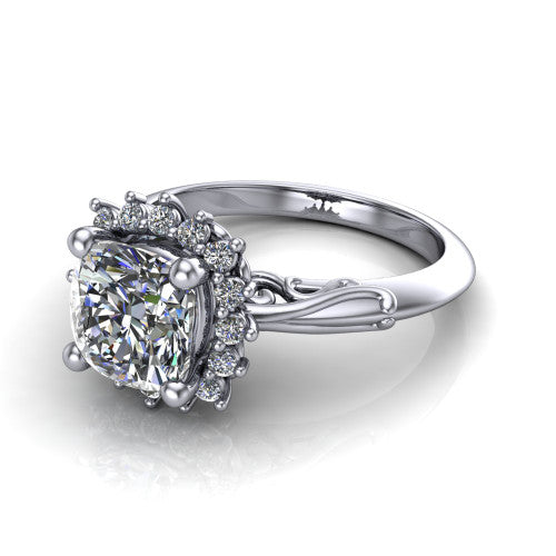 Serenity cushion halo engagement ring in Platinum, three-quarter perspective showing the cushion center diamond in a floral cluster halo with filigree shoulders