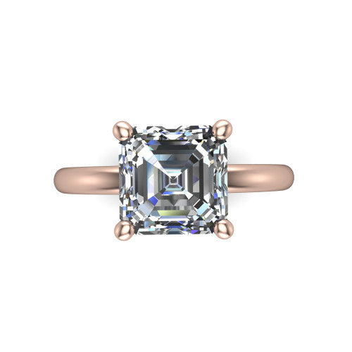 Quinn emerald solitaire engagement ring in 18K Rose Gold with hidden halo and plain band, top-down view of the four-prong center and plain band