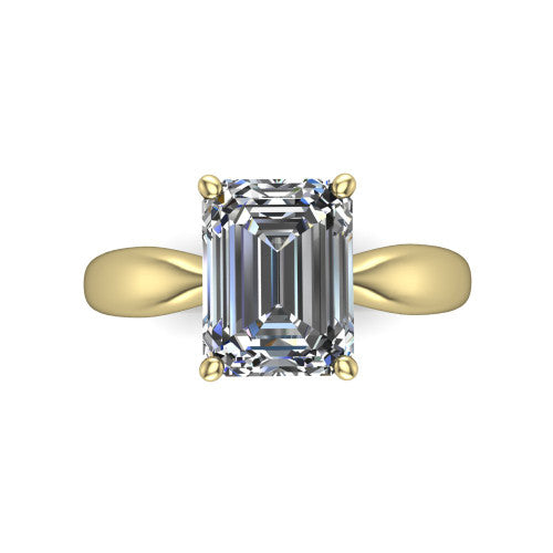 Natalie emerald solitaire engagement ring in 14K Yellow Gold on a tapered plain band, top-down view of the four-prong head and crossover gallery