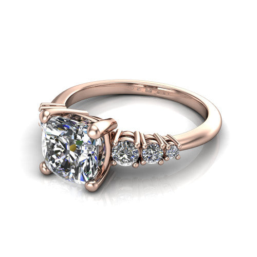 Emery cushion accent engagement ring in 14K Rose Gold with graduated round side stones, three-quarter perspective view