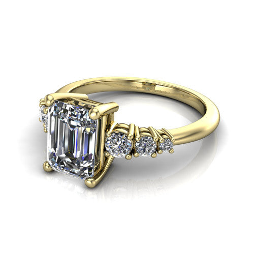 Emery emerald accent engagement ring in 14K Yellow Gold with graduated round side stones, three-quarter perspective view