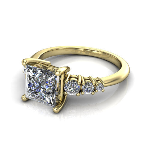 Emery princess accent engagement ring in 18K Yellow Gold with graduated round side stones, three-quarter perspective view