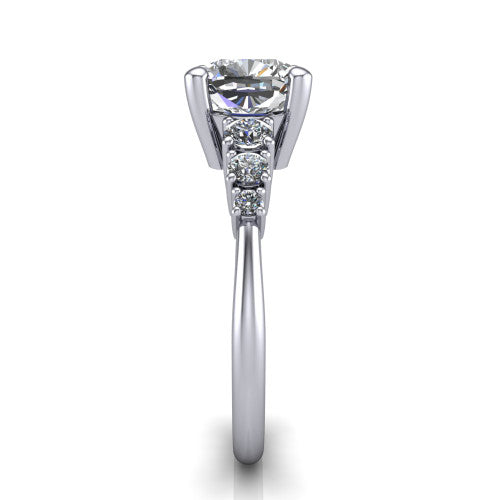 Emery cushion accent engagement ring in Platinum with graduated round side stones, side profile showing the graduated side stones and plain band