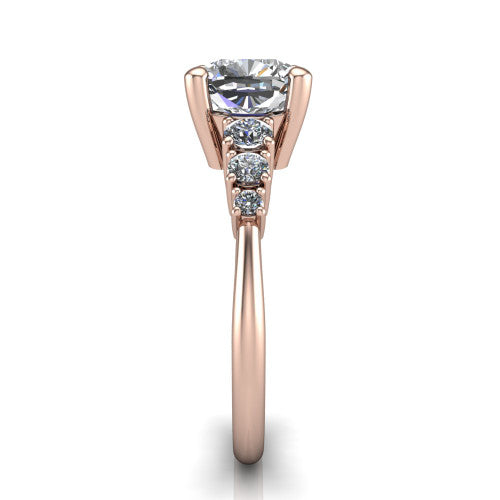 Emery cushion accent engagement ring in 14K Rose Gold with graduated round side stones, side profile showing the graduated side stones and plain band
