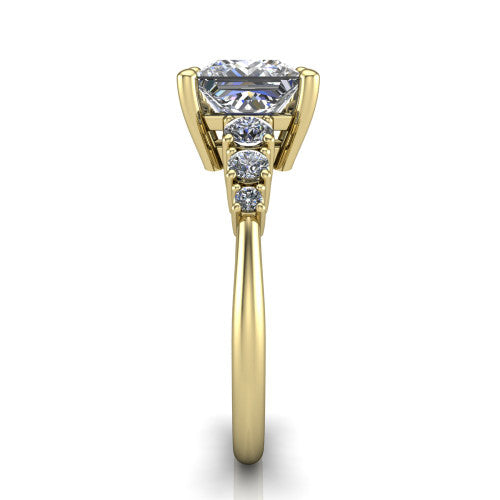Emery princess accent engagement ring in 14K Yellow Gold with graduated round side stones, side profile showing the graduated side stones and plain band