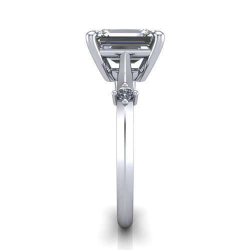 Raelynn emerald accent engagement ring in Platinum with kite-set geometric side stones, side profile showing the plain band and kite-set side accent