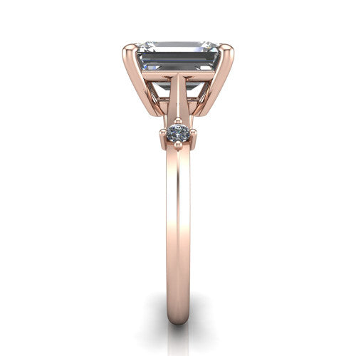 Raelynn emerald accent engagement ring in 14K Rose Gold with kite-set geometric side stones, side profile showing the plain band and kite-set side accent