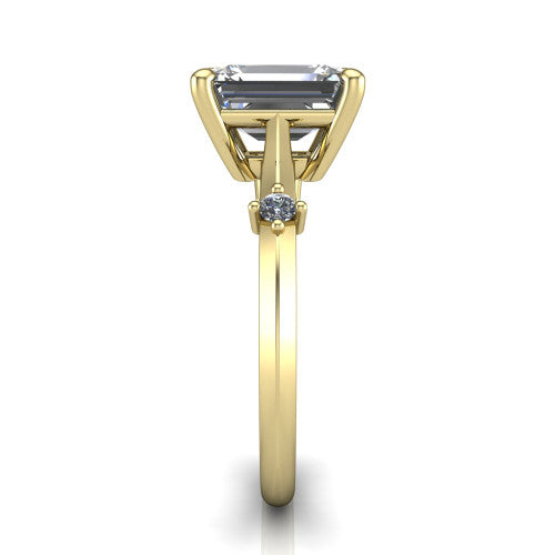 Raelynn emerald accent engagement ring in 14K Yellow Gold with kite-set geometric side stones, side profile showing the plain band and kite-set side accent