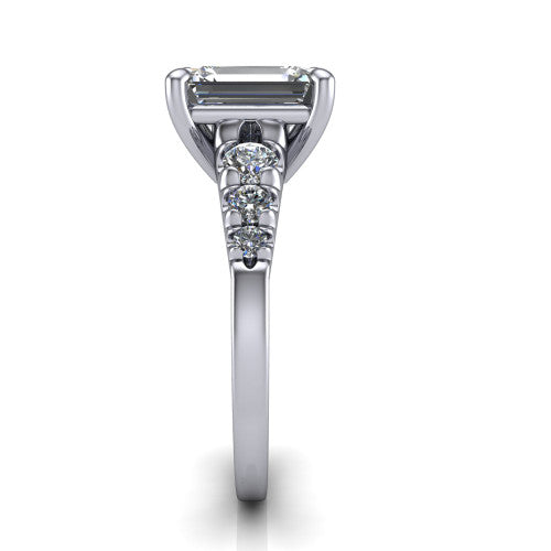 Millie emerald accent engagement ring in 18K White Gold with graduated round side stones, side profile showing the graduated side stones and plain band