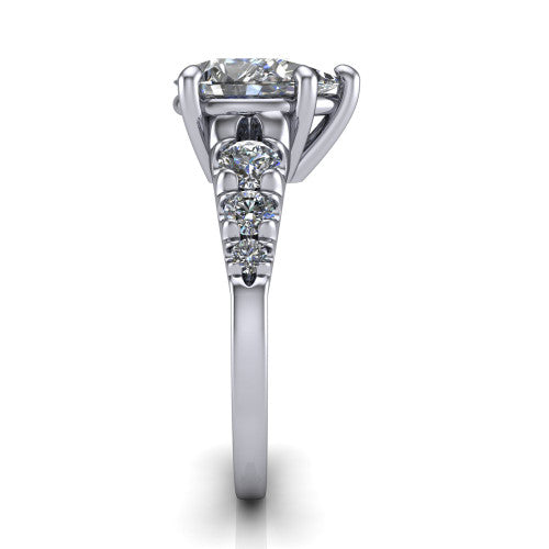 Millie pear accent engagement ring in 14K White Gold with graduated round side stones, side profile showing the graduated side stones and plain band