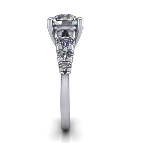 Millie round accent engagement ring in Platinum with graduated round side stones, side profile showing the graduated side stones and plain band