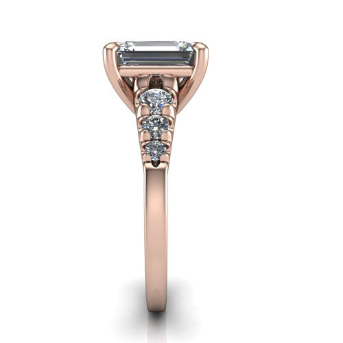 Millie emerald accent engagement ring in 18K Rose Gold with graduated round side stones, side profile showing the graduated side stones and plain band