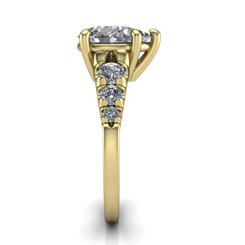 Millie pear accent engagement ring in 14K Yellow Gold with graduated round side stones, side profile showing the graduated side stones and plain band