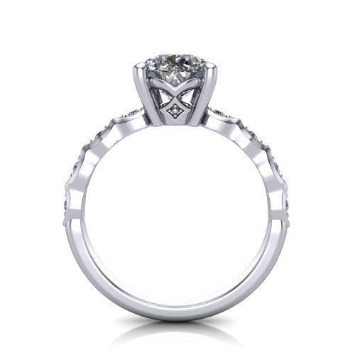 Cassie pear vintage station engagement ring in Platinum with marquise milgrain band and bezel accents, through-finger front profile showing the filigree bow gallery