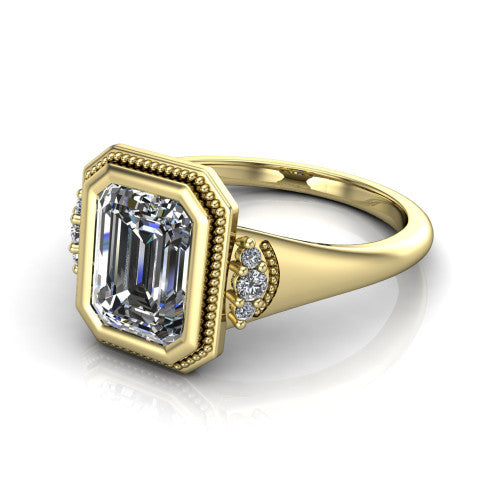 Elliana emerald bezel-set solitaire engagement ring in 14K Yellow Gold with squared milgrain bezel and pavé shoulders, three-quarter perspective view