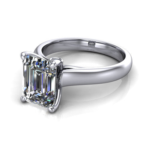 Brielle emerald solitaire engagement ring in Platinum with plain band and peek-a-boo accent, three-quarter perspective view