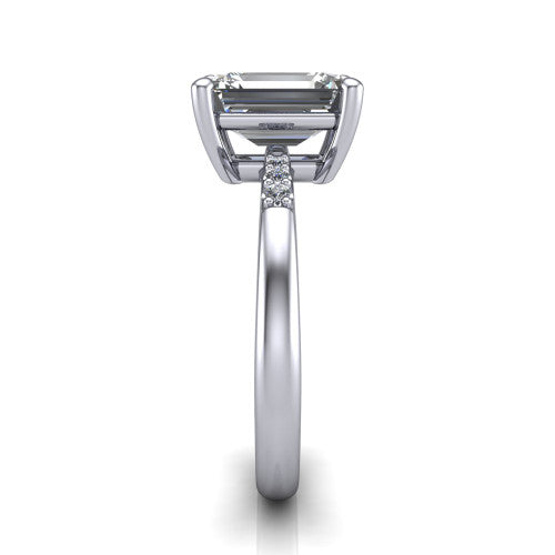 Rebecca emerald solitaire engagement ring in 18K White Gold with pavé shoulder accents, side profile showing the pavé shoulders and plain band