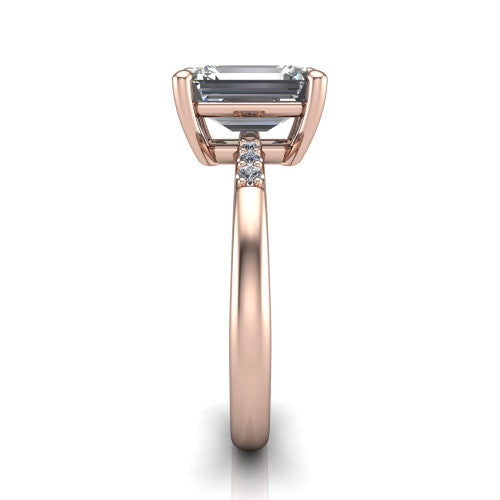Rebecca emerald solitaire engagement ring in 18K Rose Gold with pavé shoulder accents, side profile showing the pavé shoulders and plain band