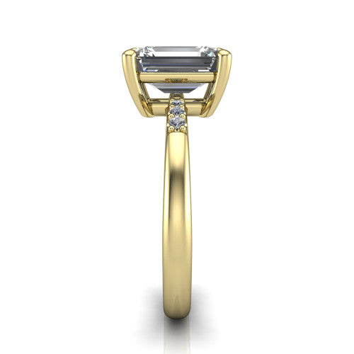 Rebecca emerald solitaire engagement ring in 18K Yellow Gold with pavé shoulder accents, side profile showing the pavé shoulders and plain band