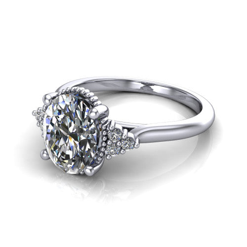 Brianna oval three stone engagement ring in Platinum with milgrain-framed center and round side clusters, three-quarter perspective view