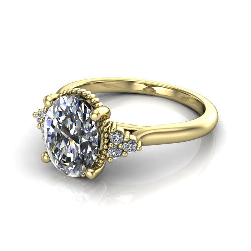 Brianna oval three stone engagement ring in 18K Yellow Gold with milgrain-framed center and round side clusters, three-quarter perspective view