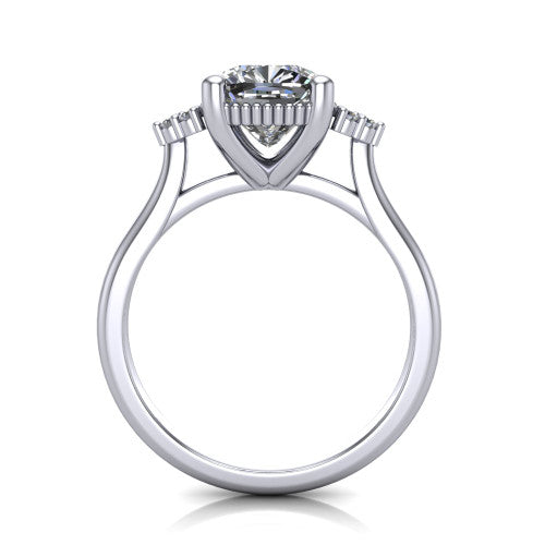 Brianna cushion three stone engagement ring in Platinum with milgrain-framed center and round side clusters, through-finger front profile