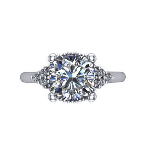 Brianna cushion three stone engagement ring in 18K White Gold with milgrain-framed center and round side clusters, top-down view of the milgrain-framed center and side accent clusters