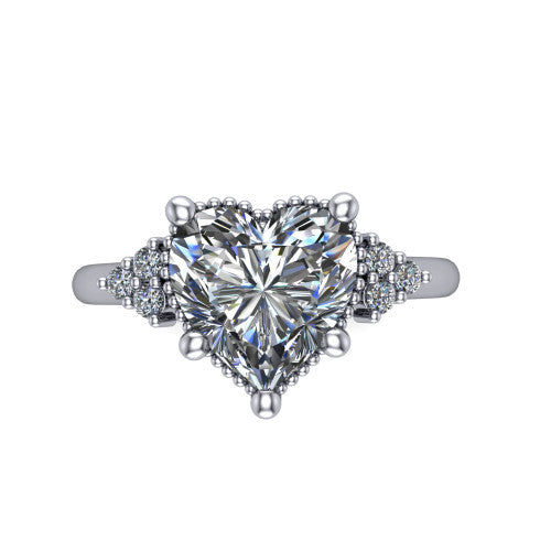 Brianna heart three stone engagement ring in Platinum with milgrain-framed center and round side clusters, top-down view of the milgrain-framed center and side accent clusters