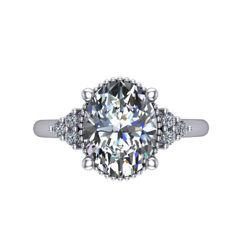 Brianna oval three stone engagement ring in 18K White Gold with milgrain-framed center and round side clusters, top-down view of the milgrain-framed center and side accent clusters