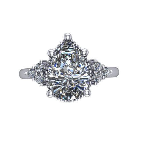 Brianna pear three stone engagement ring in 18K White Gold with milgrain-framed center and round side clusters, top-down view of the milgrain-framed center and side accent clusters