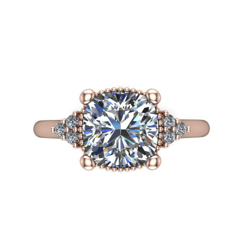 Brianna cushion three stone engagement ring in 18K Rose Gold with milgrain-framed center and round side clusters, top-down view of the milgrain-framed center and side accent clusters