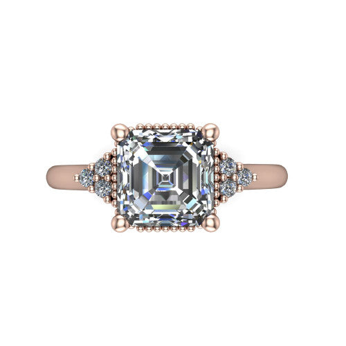 Brianna asscher three stone engagement ring in 14K Rose Gold with milgrain-framed center and round side clusters, top-down view of the milgrain-framed center and side accent clusters