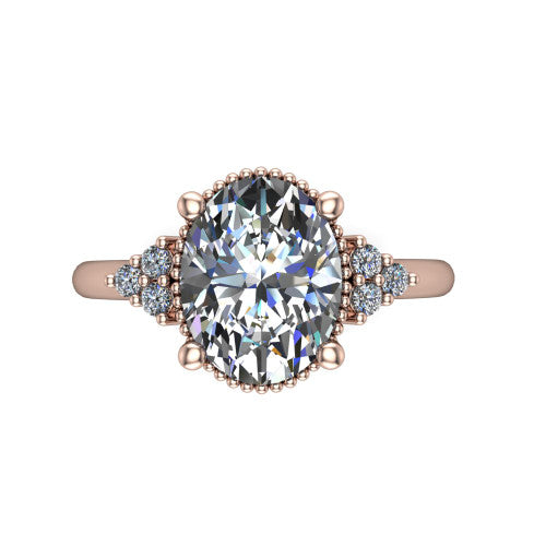 Brianna oval three stone engagement ring in 14K Rose Gold with milgrain-framed center and round side clusters, top-down view of the milgrain-framed center and side accent clusters