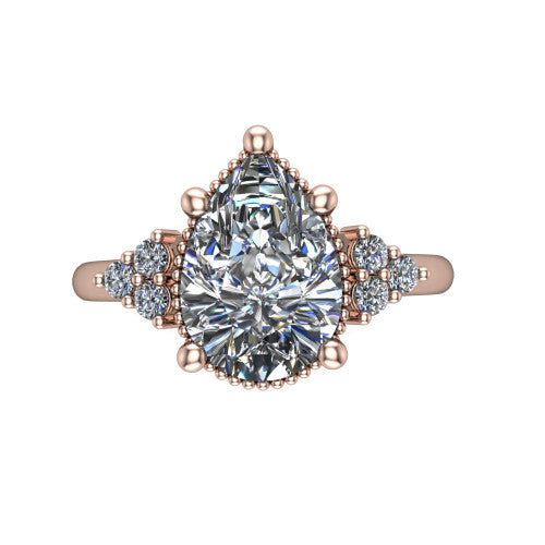 Brianna pear three stone engagement ring in 14K Rose Gold with milgrain-framed center and round side clusters, top-down view of the milgrain-framed center and side accent clusters