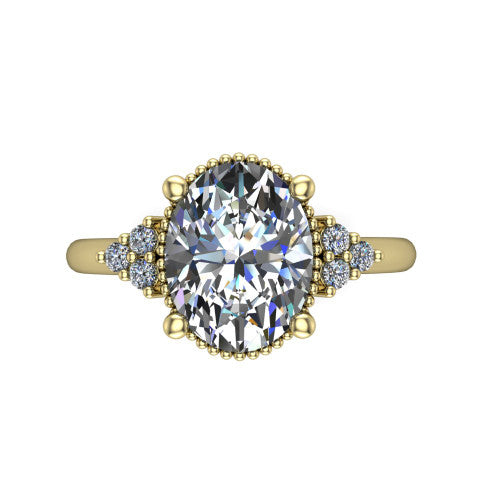 Brianna oval three stone engagement ring in 18K Yellow Gold with milgrain-framed center and round side clusters, top-down view of the milgrain-framed center and side accent clusters