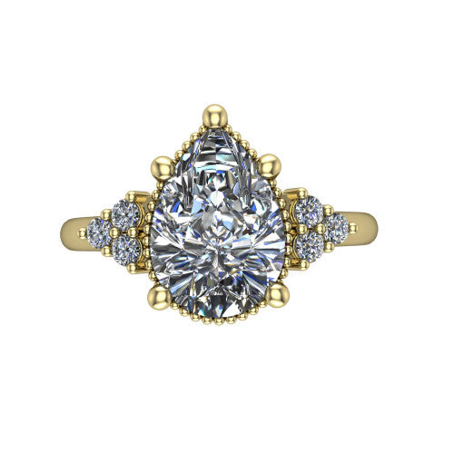 Brianna pear three stone engagement ring in 14K Yellow Gold with milgrain-framed center and round side clusters, top-down view of the milgrain-framed center and side accent clusters
