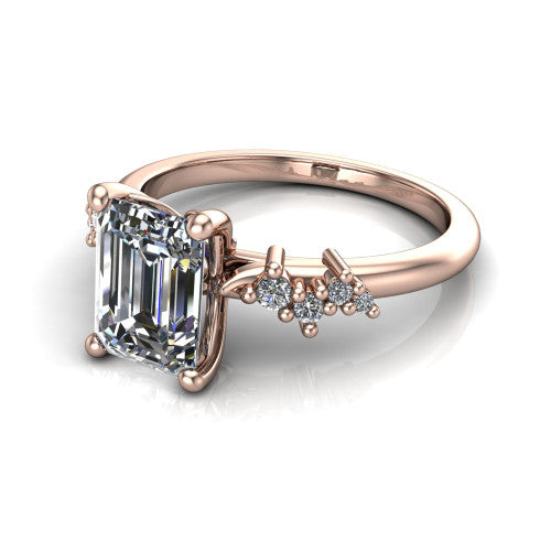 Georgia emerald-cut classic engagement ring in 14K Rose Gold, three-quarter perspective showing the emerald-cut center diamond and scattered cluster accents on the band