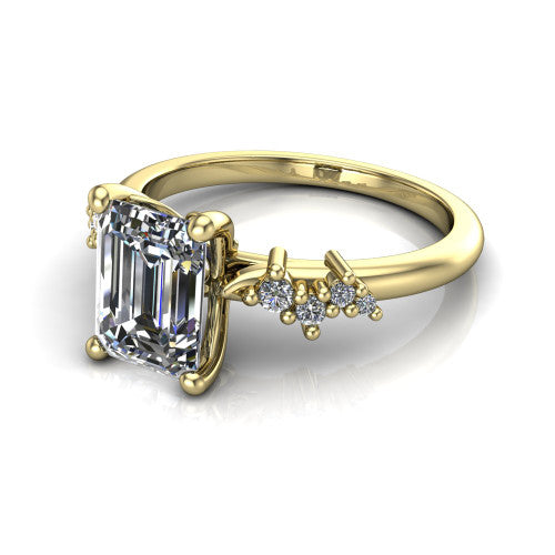 Georgia emerald-cut classic engagement ring in 18K Yellow Gold, three-quarter perspective showing the emerald-cut center diamond and scattered cluster accents on the band