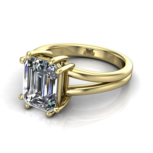 Lainey emerald-cut solitaire engagement ring in 14K Yellow Gold, three-quarter perspective showing the emerald-cut center diamond raised in a double-claw prong head on a polished band