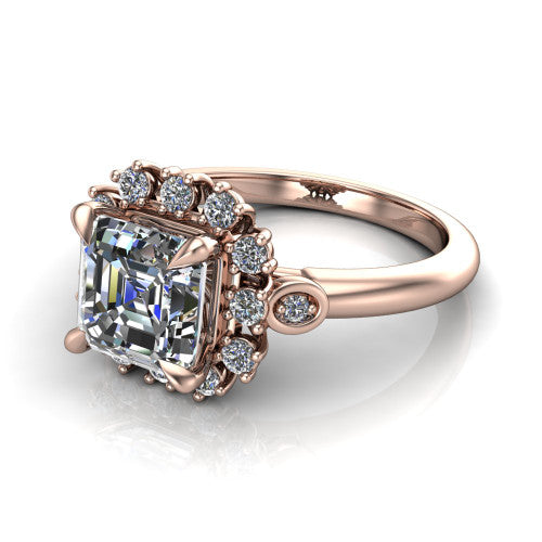 June square emerald-cut halo engagement ring in 14K Rose Gold, three-quarter perspective showing the square emerald-cut center diamond in an ornate cluster halo with bezel side accents