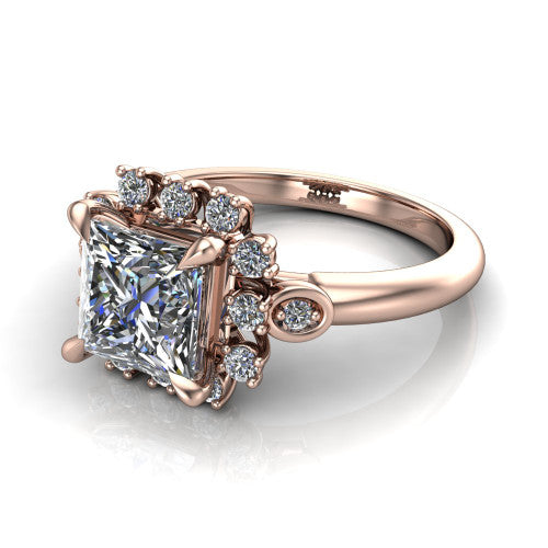 June princess-cut halo engagement ring in 14K Rose Gold, three-quarter perspective showing the princess-cut center diamond in an ornate cluster halo with bezel side accents