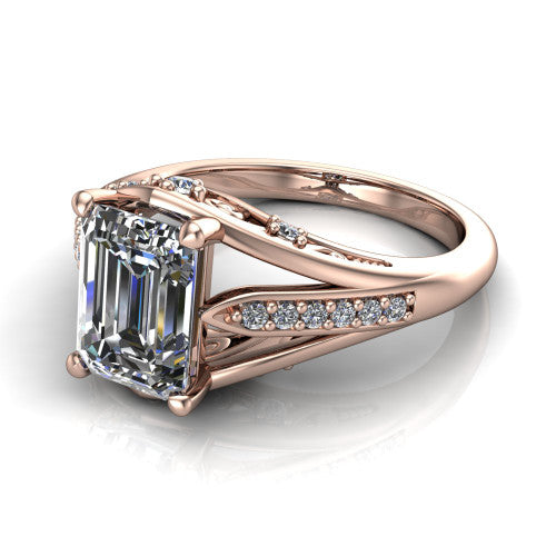 Blakely emerald-cut solitaire engagement ring in 14K Rose Gold, three-quarter perspective showing the emerald-cut center diamond above a split-shank pave band with filigree gallery