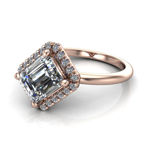 Callie emerald-cut halo engagement ring in 14K Rose Gold, three-quarter perspective showing the emerald-cut center diamond set diagonally in a pave halo on a thin band
