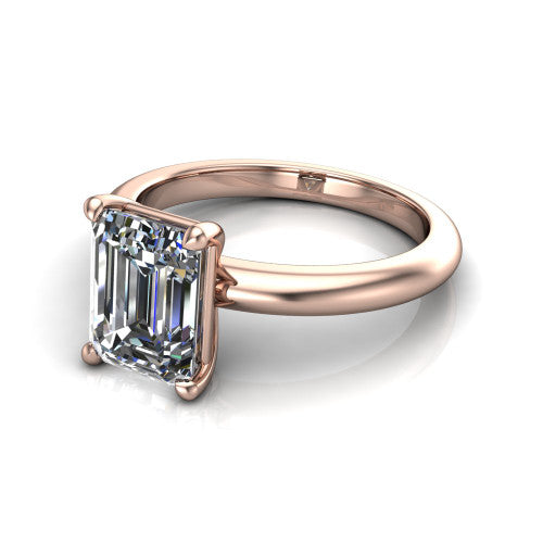 Noelle emerald classic solitaire engagement ring in 14K Rose Gold, three-quarter perspective showing the prong-set center raised above a slim plain polished band