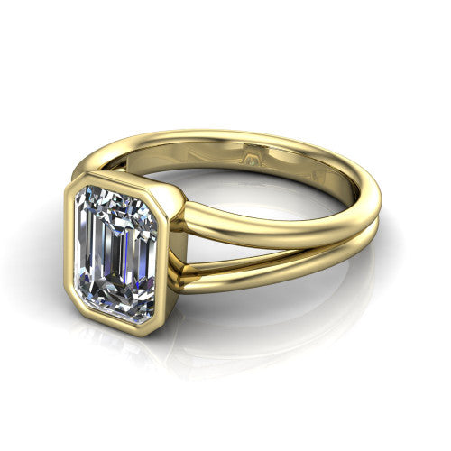 Emersyn emerald-cut classic engagement ring in 18K Yellow Gold, three-quarter perspective showing the bezel-set emerald-cut center diamond and split shank