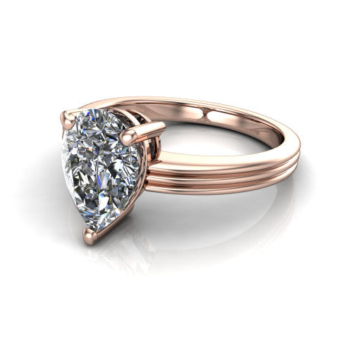 Reagan pear classic engagement ring in 18K Rose Gold, three-quarter perspective showing the pear center diamond above a grooved polished band
