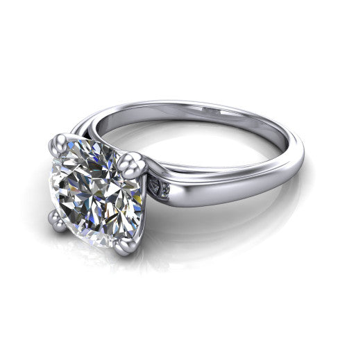 Erika round classic engagement ring in 18K White Gold, three-quarter perspective showing the round center diamond in a four-prong head on a polished band