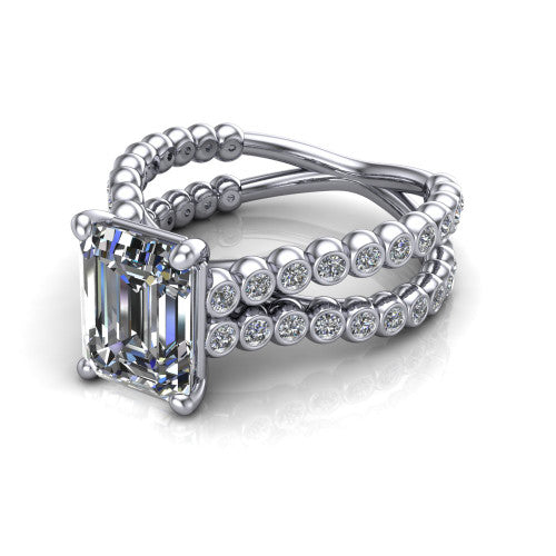 Magnolia emerald-cut classic engagement ring in Platinum, three-quarter perspective showing the emerald-cut center diamond in a four-prong head above a split bezel-set diamond band