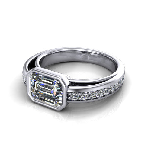 Isabel emerald-cut classic engagement ring in 18K White Gold, three-quarter perspective showing the emerald-cut center diamond in a full bezel above a split diamond band